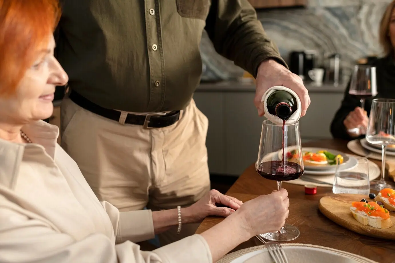 Close-up of a man pouring a drink into a glass